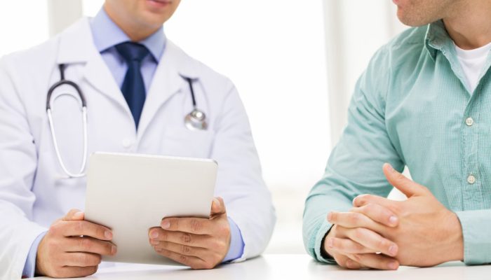 medicine, health care, people and technology concept - close up of f male doctor and patient hands with tablet pc computer
